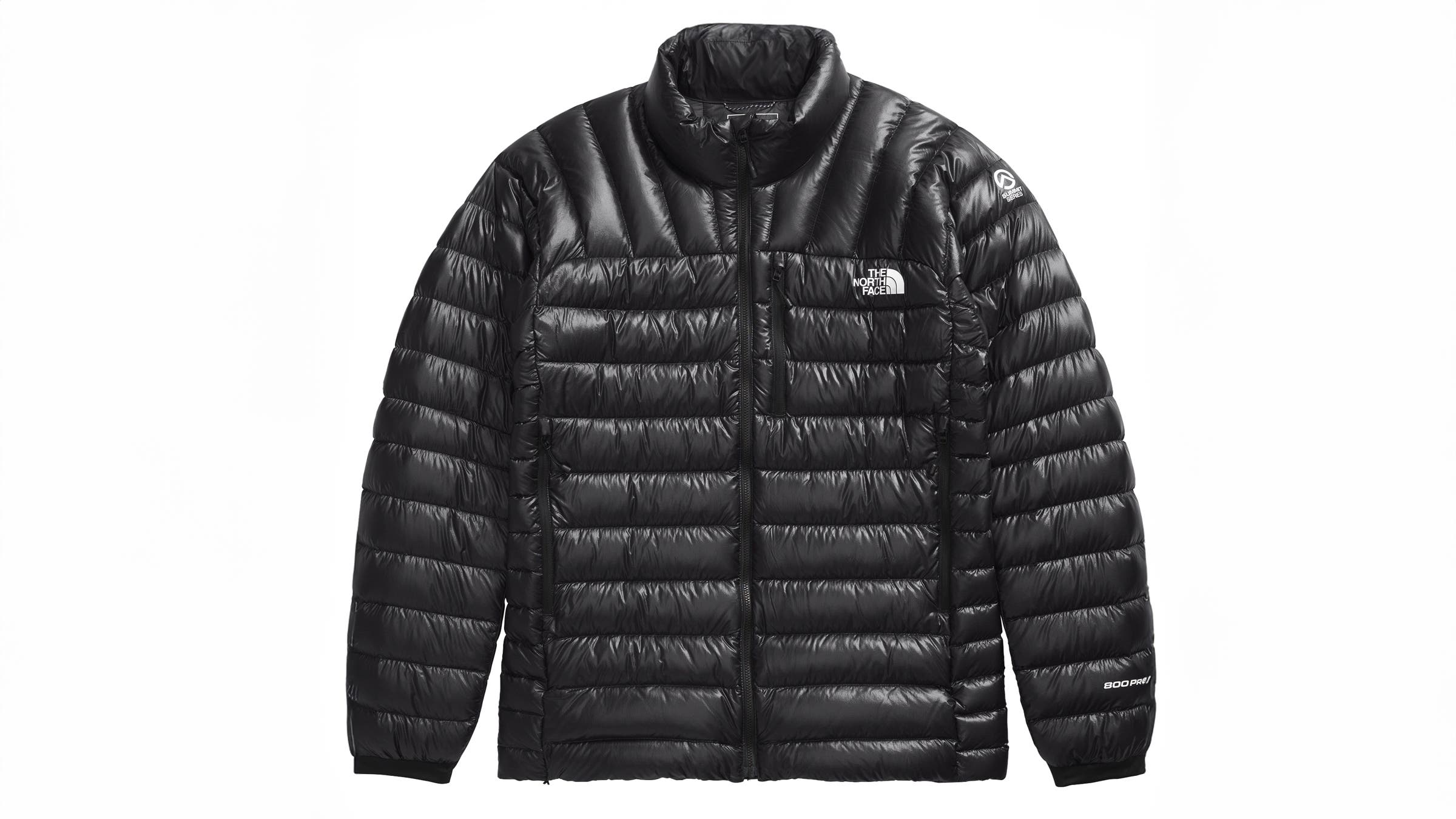 Black down-insulated jacket from The North Face Summit Series laid flat. Provides lightweight, packable warmth for chilly nights while fastpacking.